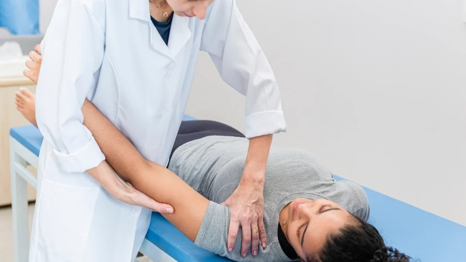Physiotherapist supporting a patient's arm during treatment