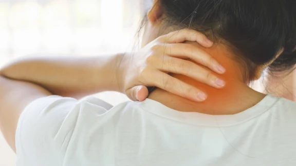 Woman holding her neck in pain, area highlighted